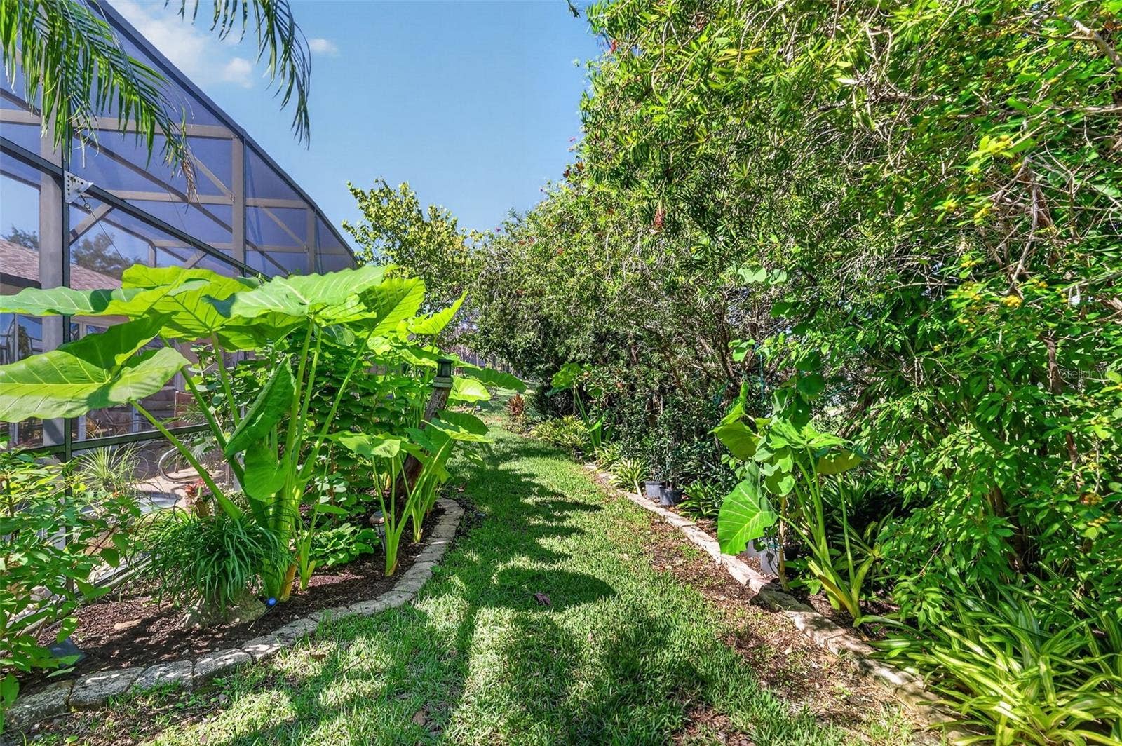 6121 HUNTERS RIDGE AVENUE, Leesburg, FL 34748 Rear Elevation with Tropical PRIVACY Landscaping!