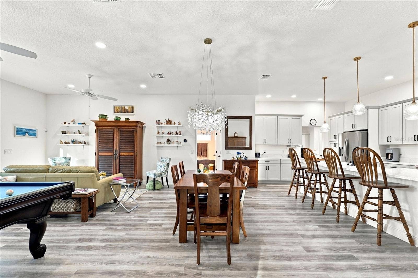 614 LAKE CREEK CIRCLE, The Villages, FL 34762 Dining Room with Living Room to the left and Kitchen to the right
