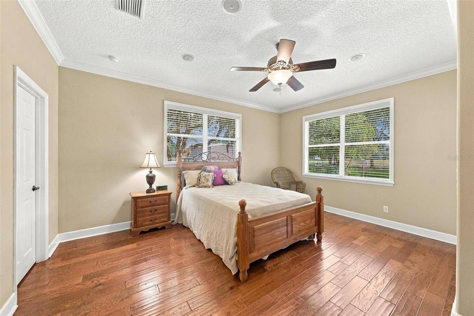 15330 SKY LAKE LANE, Tavares, FL 32778 2ND PRIMARY SUITE IN GUEST WING WITH LARGE WINDOWS & CROWN MOLDING.