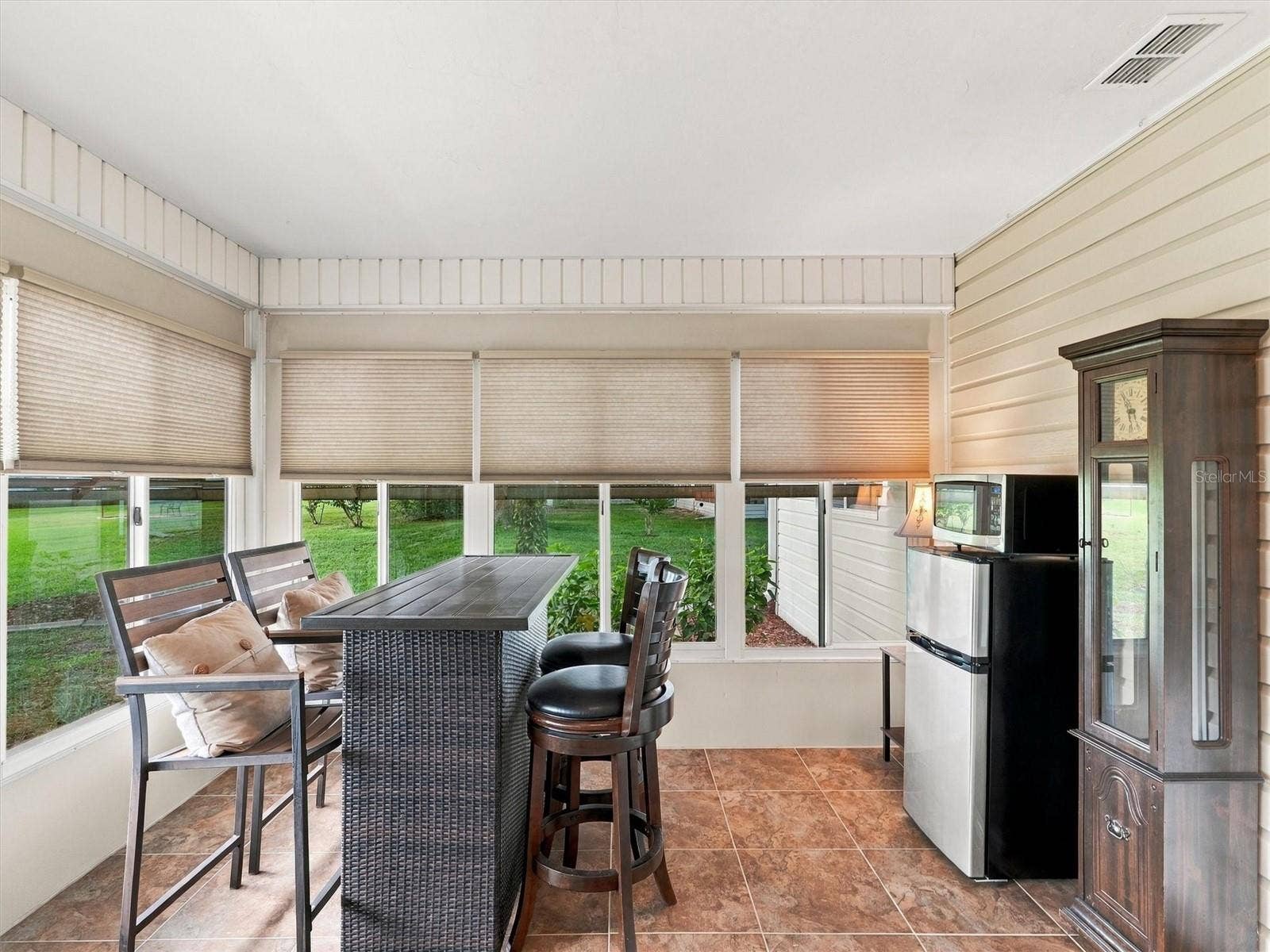 9892 SE 177TH LANE, Summerfield, FL 34491 Lanai / Den includes a High Top Table and Fridge/Microwave