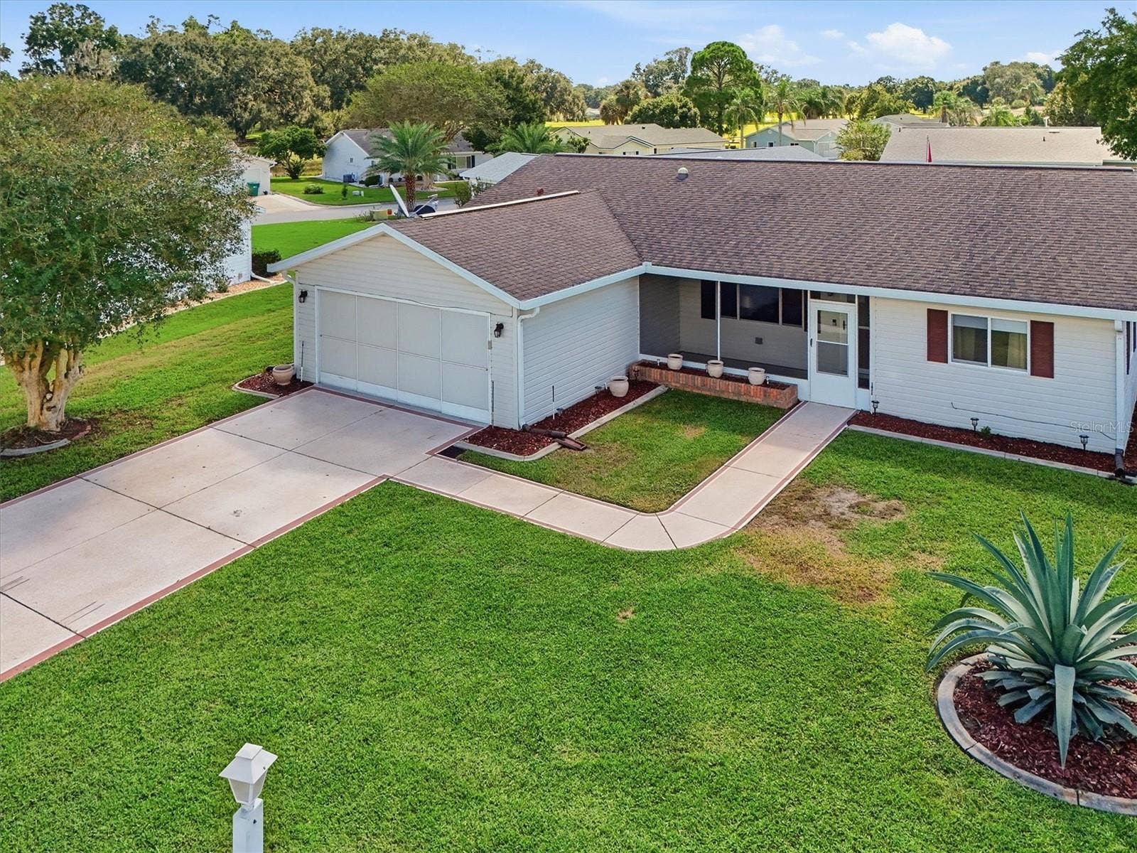 9892 SE 177TH LANE, Summerfield, FL 34491 House includes a Screen Garage Door and Front Screen Porch perfect for morning coffee.