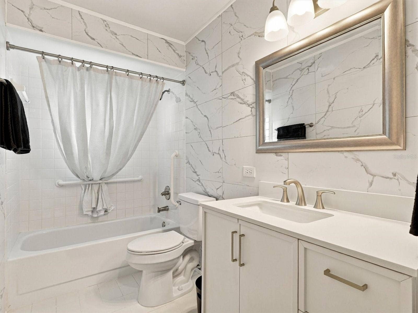 9892 SE 177TH LANE, Summerfield, FL 34491 Guest Bathroom - updated with new vanity, wall tiles, mirror, toilet