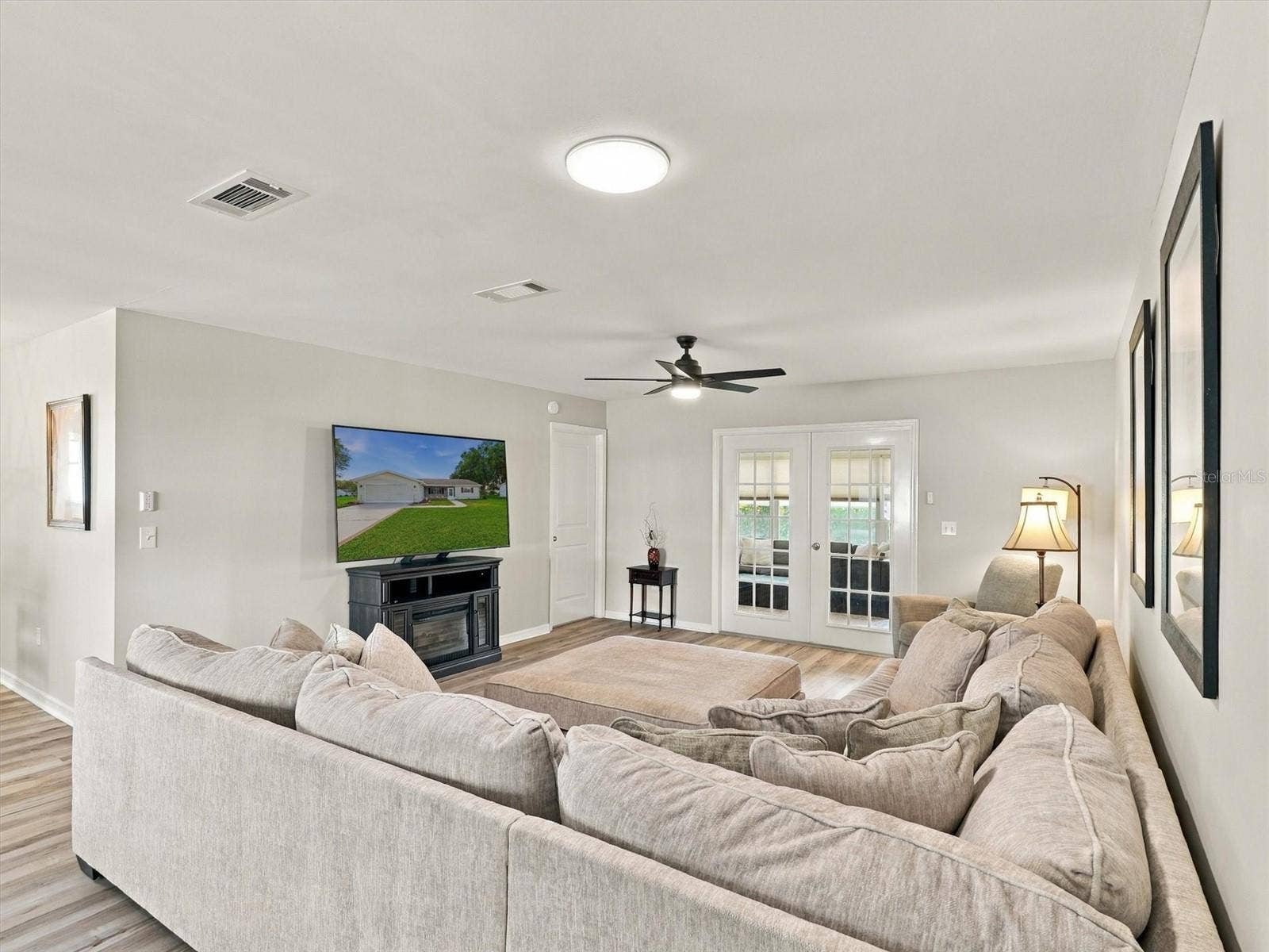 9892 SE 177TH LANE, Summerfield, FL 34491 Living Room with Comfortable Sofa and 65" TV, Solar Tube