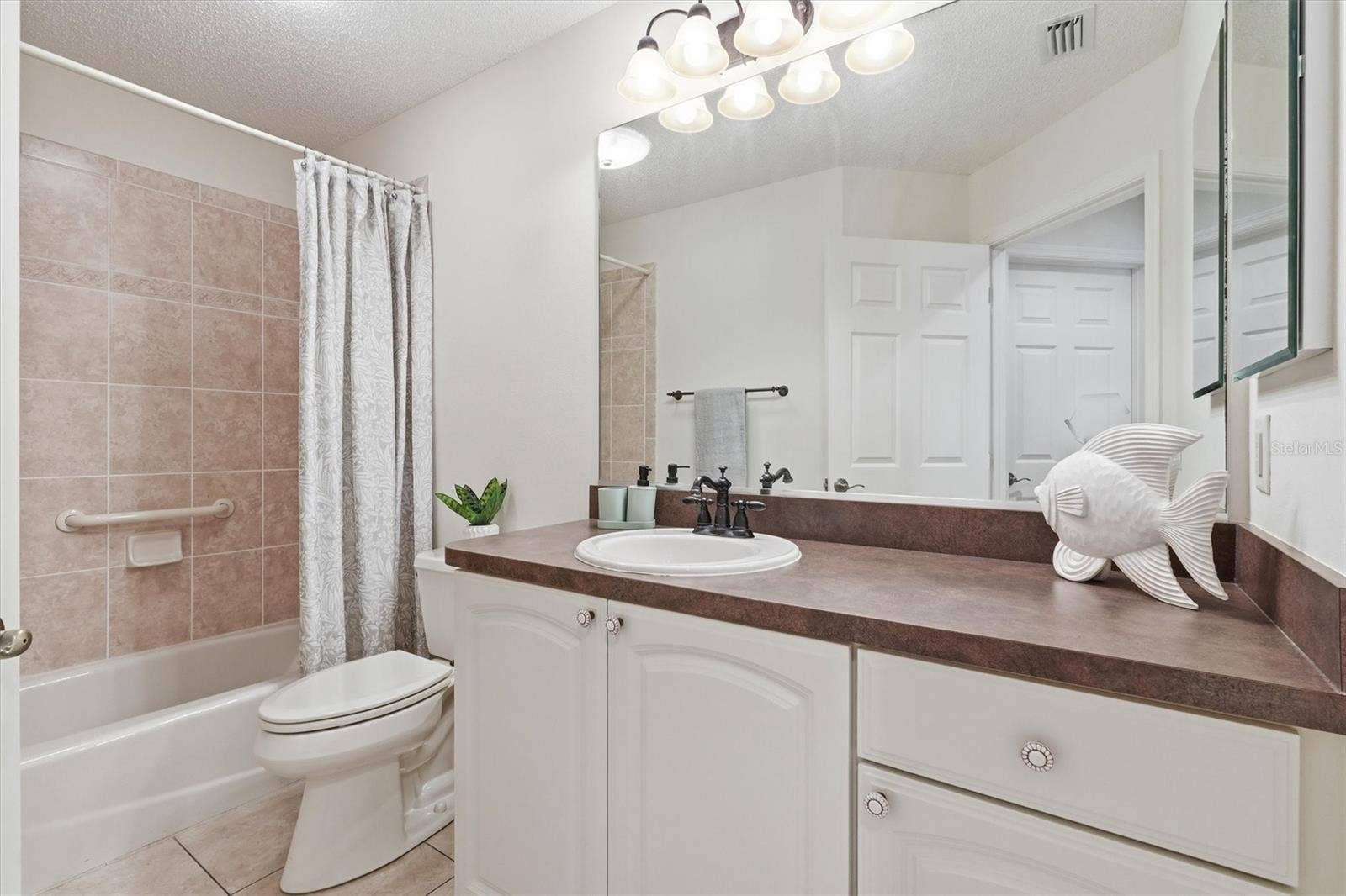 1563 EASTOVER TERRACE, The Villages, FL 32162 Guest Bathroom, high countertops, Tile Shower/Tub combo. Linen closet in hallway.