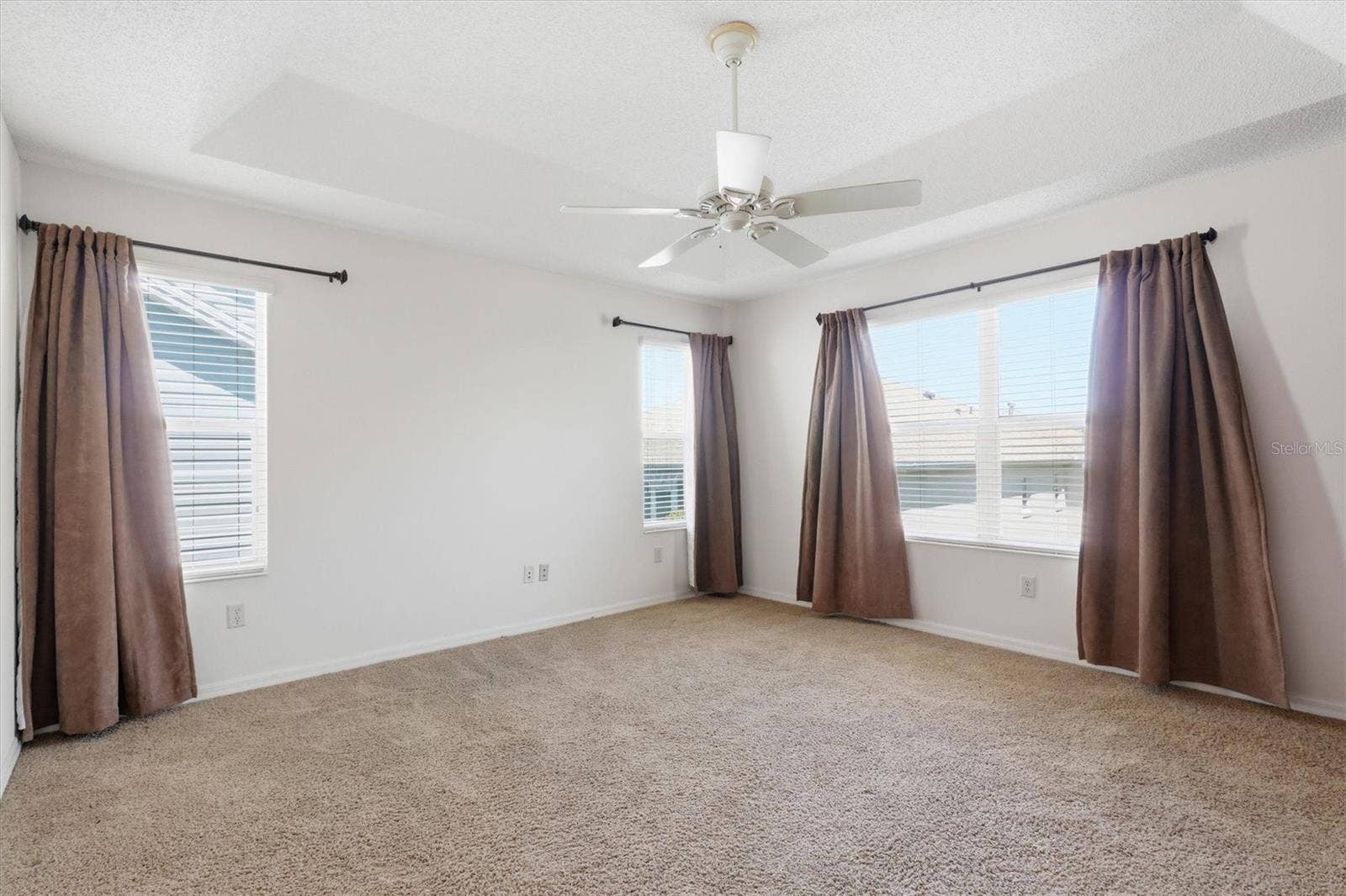 1563 EASTOVER TERRACE, The Villages, FL 32162 Primary Bedroom with Tray Ceiling, plenty of windows for that added natural light.
