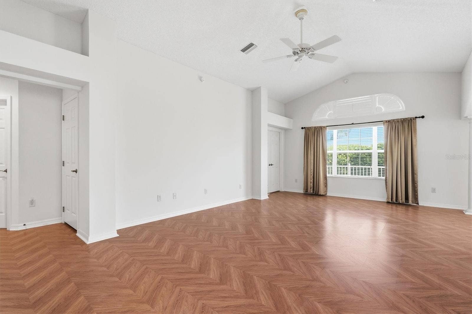 1563 EASTOVER TERRACE, The Villages, FL 32162 Living Room - Vaulted Ceilings with Herringbone Parquet Flooring.