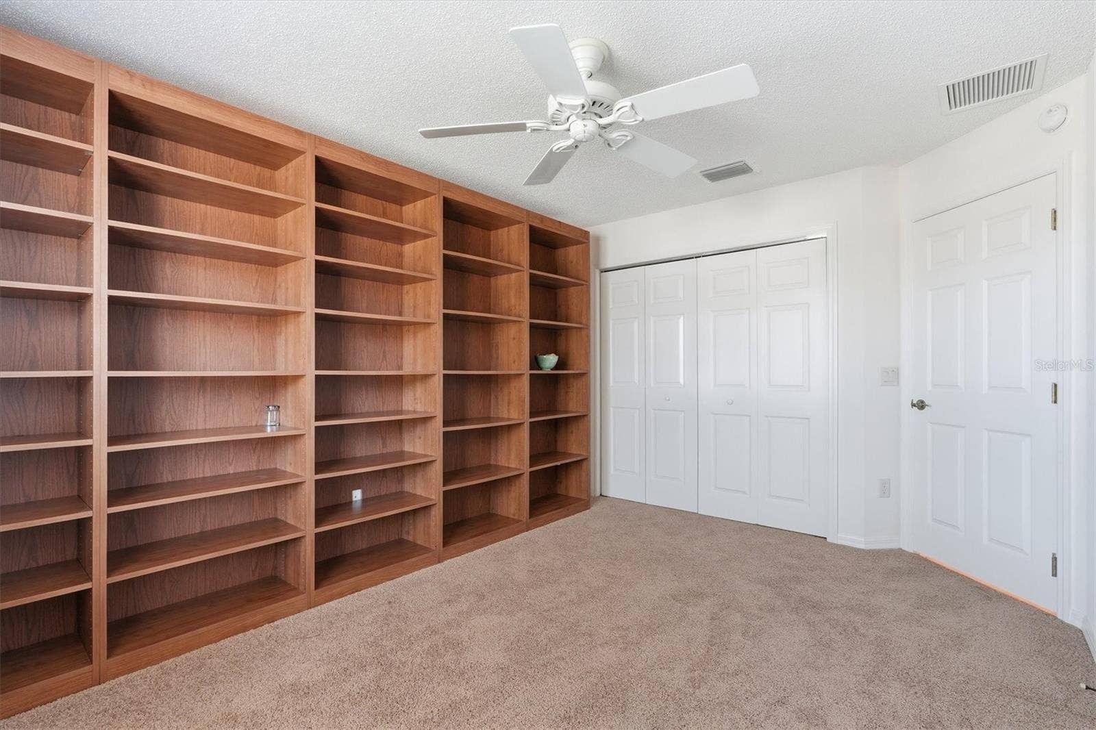1563 EASTOVER TERRACE, The Villages, FL 32162 Bedroom #2 has custom bookshelves, perfect for a Office.