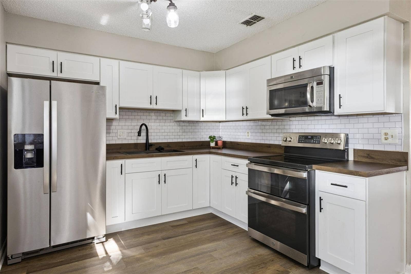 416 WINNERS CIRCLE, Lady Lake, FL 32159 Kitchen has newer cabinets, counter, sink, faucet and appliances!