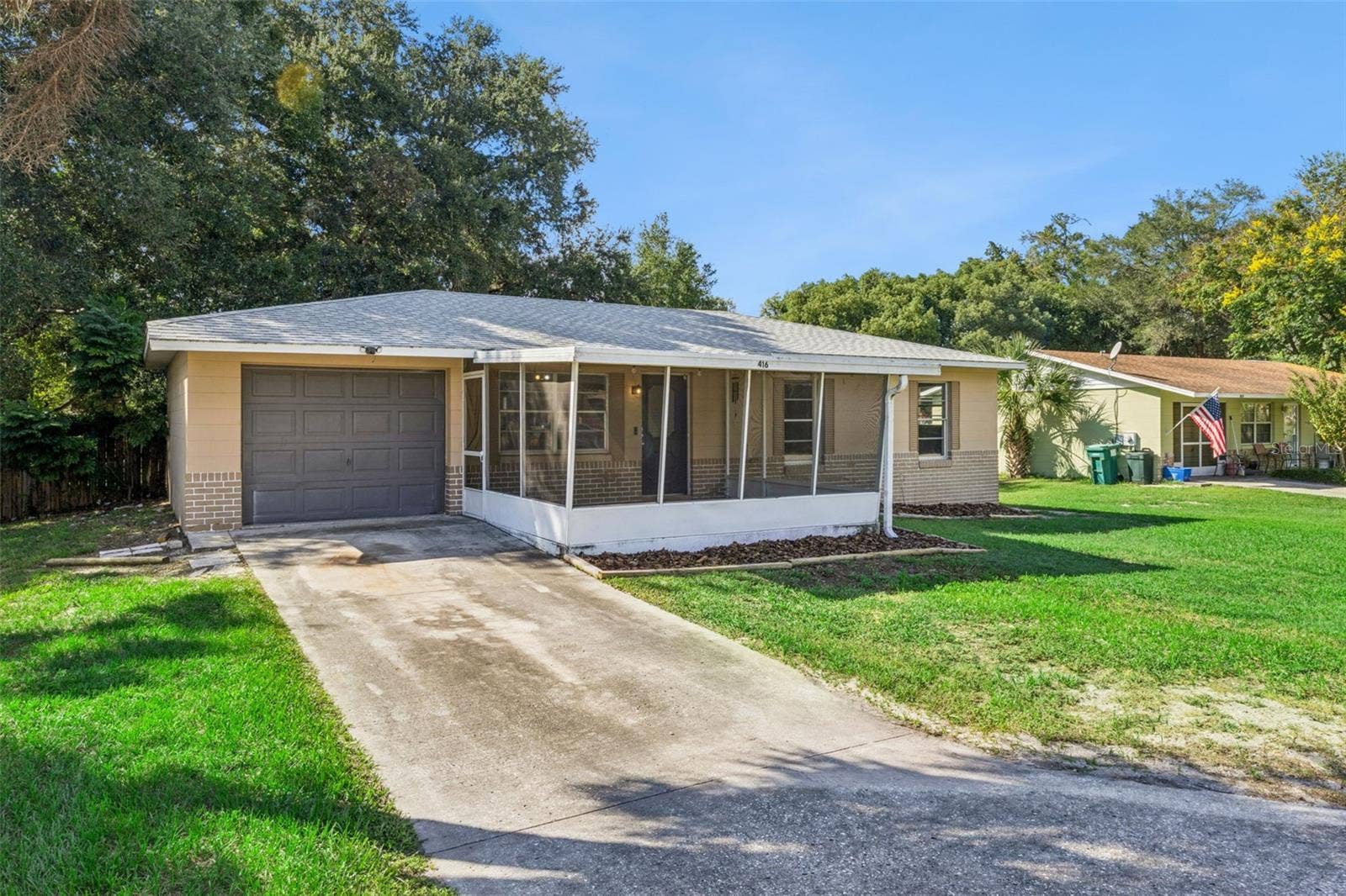 416 WINNERS CIRCLE, Lady Lake, FL 32159 Driveway to 1-car garage.