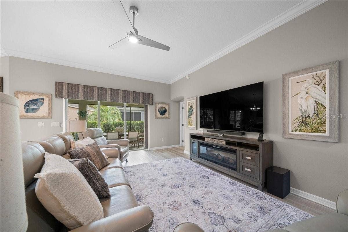 Living Room Features Crown Molding & Updated Fan / Light