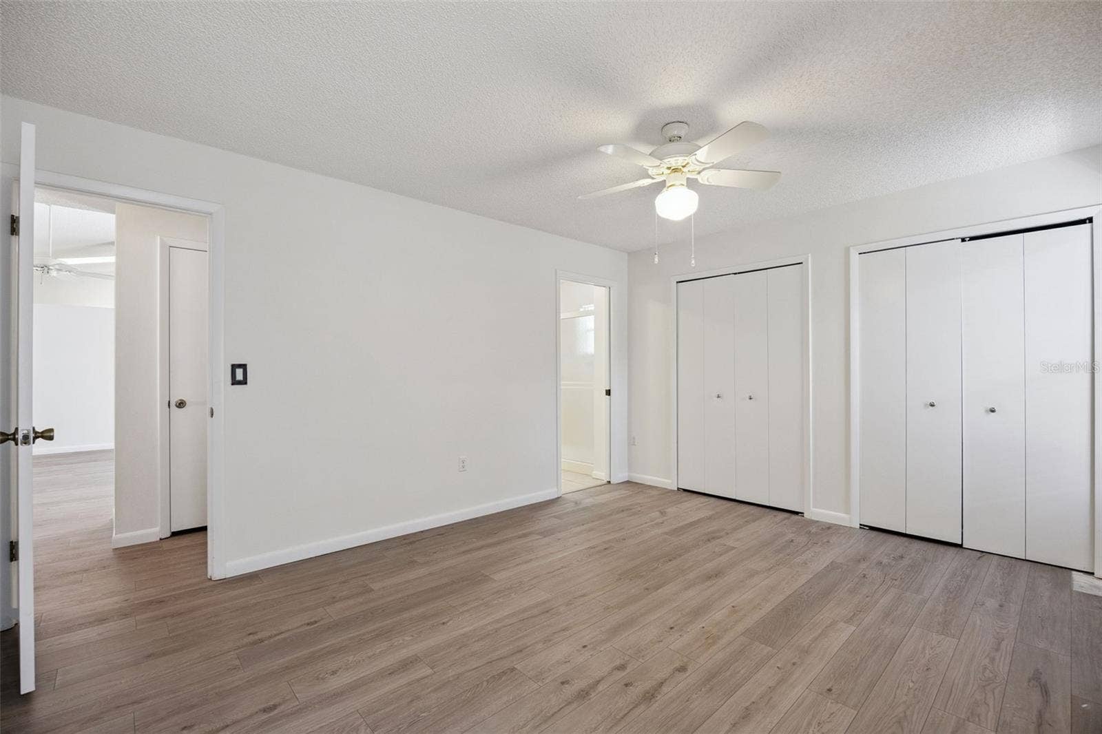 Primary retreat with en suite bath and direct access to the pool and rear patio