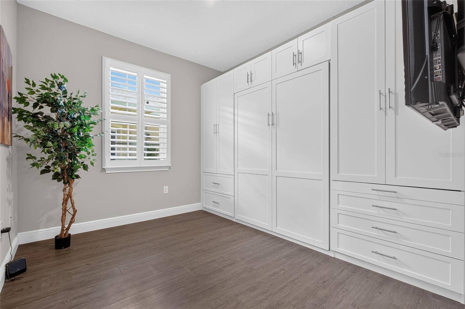 4408 BEDFORD WAY, Leesburg, FL 34748 second bedroom. Murphy bed is available, custom cabinetry on right does not convey