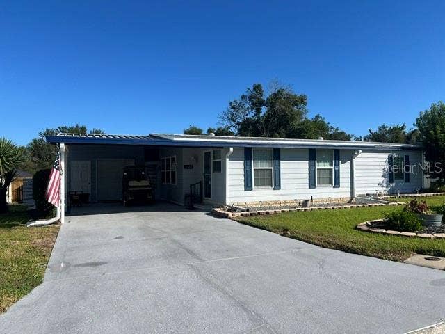 2368 CONESTOGA DRIVE, Leesburg, FL 34748 Larger Carport with view of Storage area at back of carport