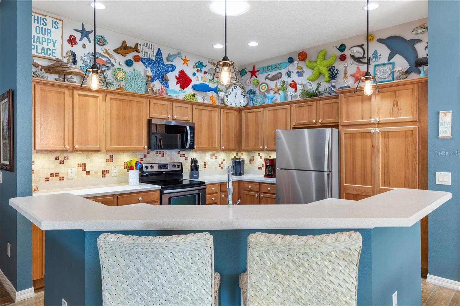 2398 FLATWOOD STREET, The Villages, FL 32162 KITCHEN WITH BAR STOOLS