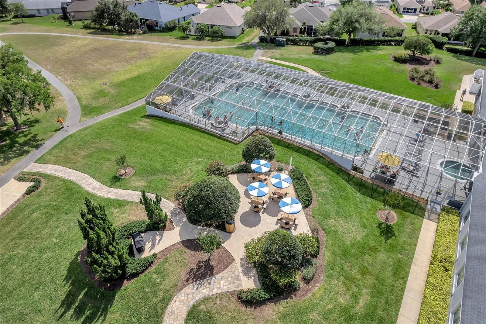 4900 CANOE COURT, Tavares, FL 32778 Pool with shaded picnic tables.