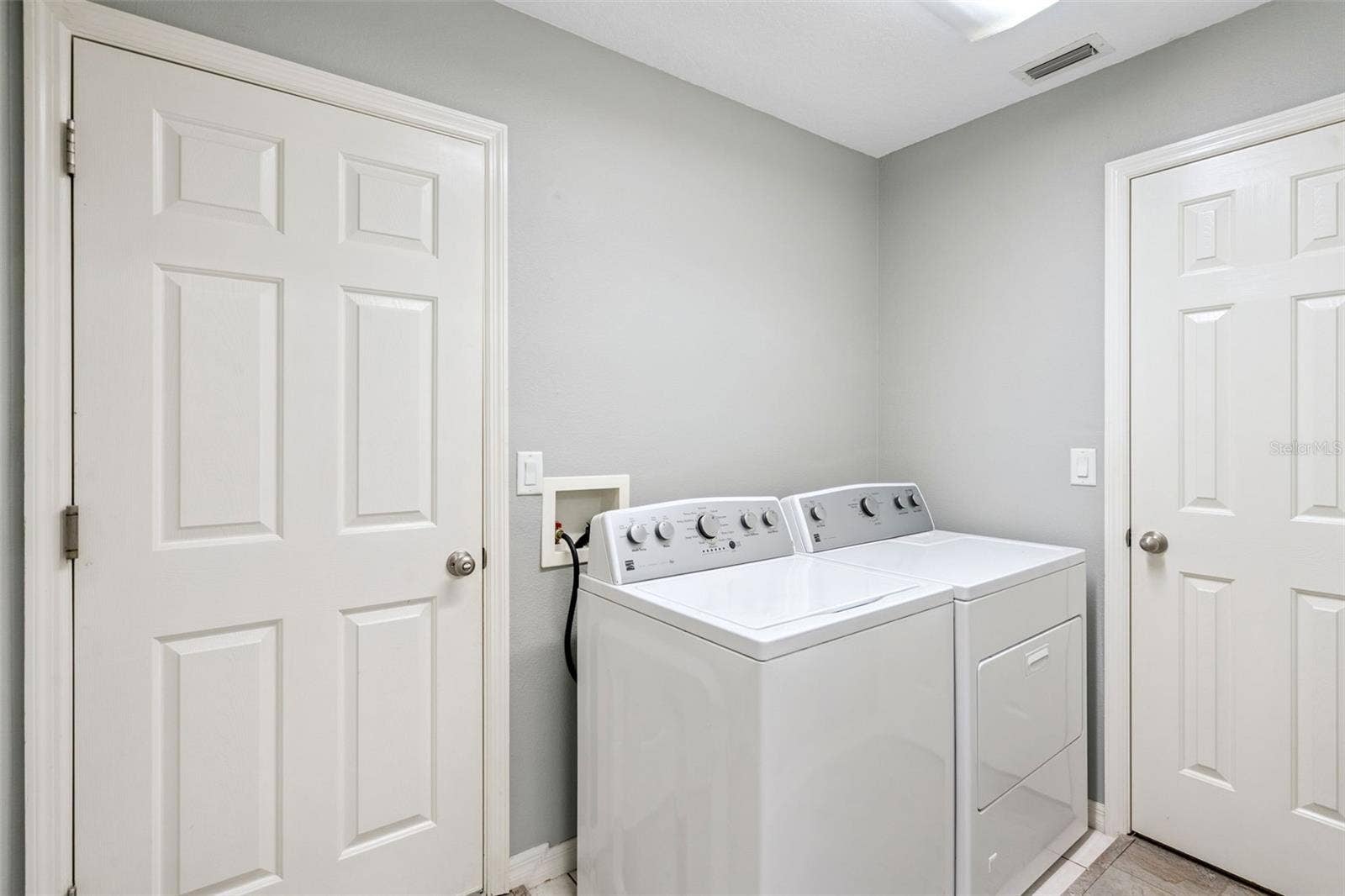 4900 CANOE COURT, Tavares, FL 32778 Inside laundry room has additional storage pantry.