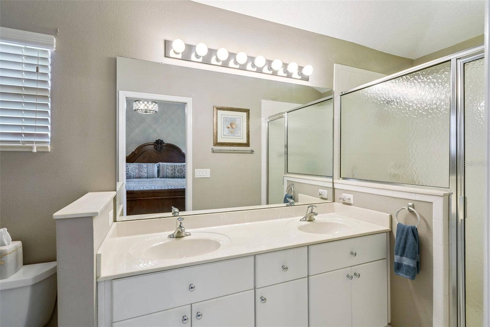 4900 CANOE COURT, Tavares, FL 32778 Primary bath with dual sinks and walk-in shower.