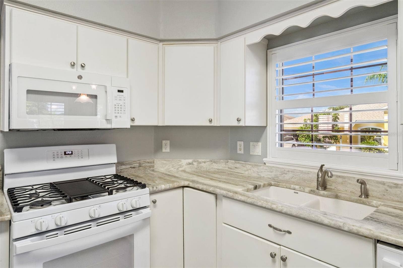 4900 CANOE COURT, Tavares, FL 32778 Granite counters and a window over the sink.