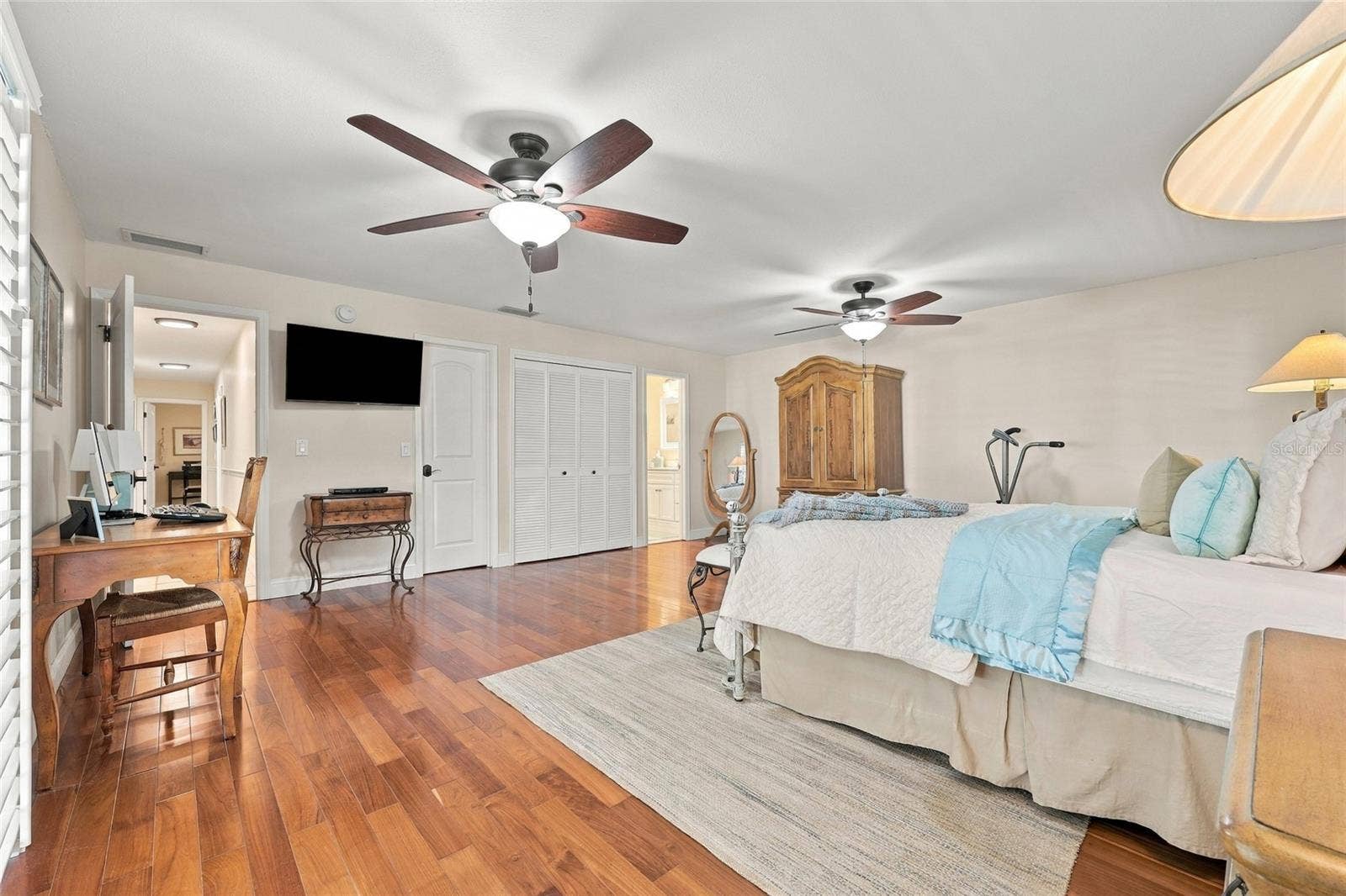 13205 MARIA AVENUE, Clermont, FL 34711 Primary bedroom with teak engineered floors & plantation shutters