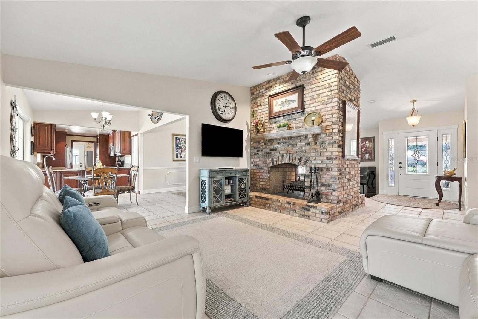 13205 MARIA AVENUE, Clermont, FL 34711 Family room with wood burning fireplace