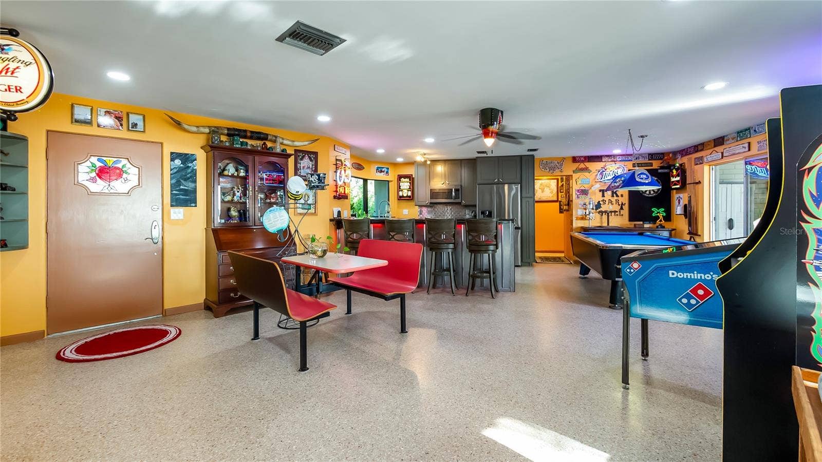 1730 NITA PLACE, Clermont, FL 34711 Main Home - Great room/kitchen/living room combo: Living room used as gathering space for game room fun. Two Sliders go out to covered back porch and screened in pool