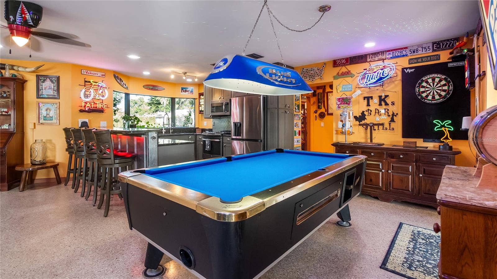 1730 NITA PLACE, Clermont, FL 34711 Main Home - Great room/kitchen/living room combo: Living room used as gathering space for game room fun. Two Sliders go out to covered back porch and screened in pool