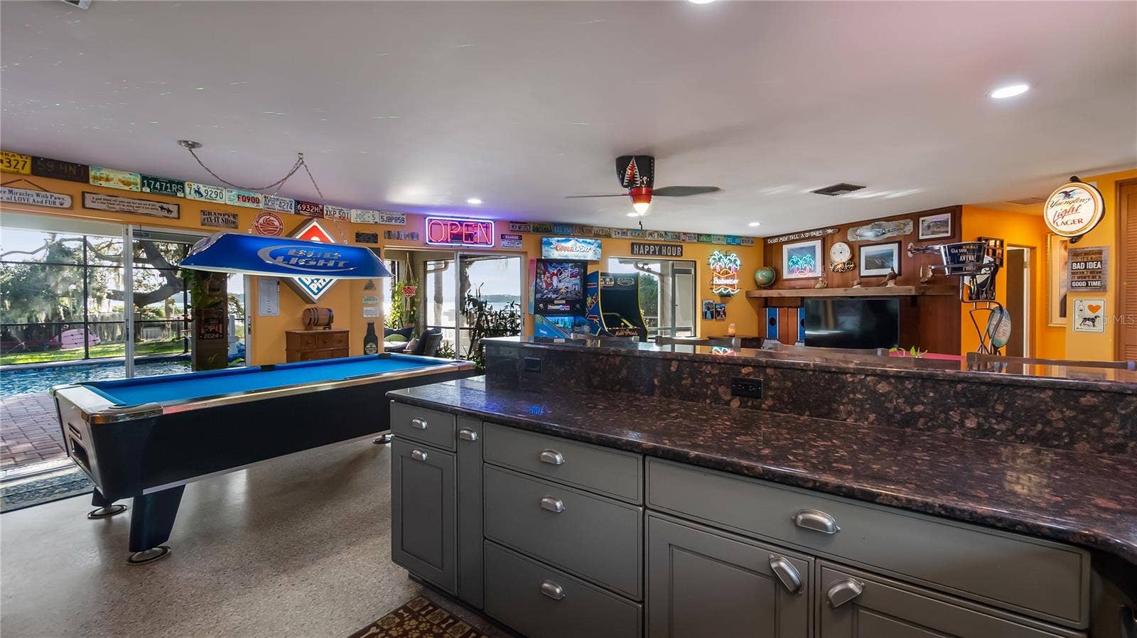 1730 NITA PLACE, Clermont, FL 34711 Main Home - Great room/kitchen/living room combo: Living room used as gathering space for game room fun. Two Sliders go out to covered back porch and screened in pool