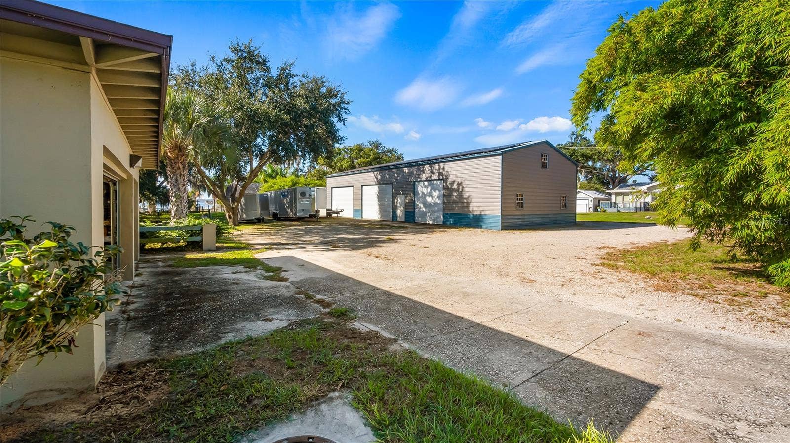 1730 NITA PLACE, Clermont, FL 34711 Driveway off Lakeshore Dr to detached garage apartment and backside of metal building.