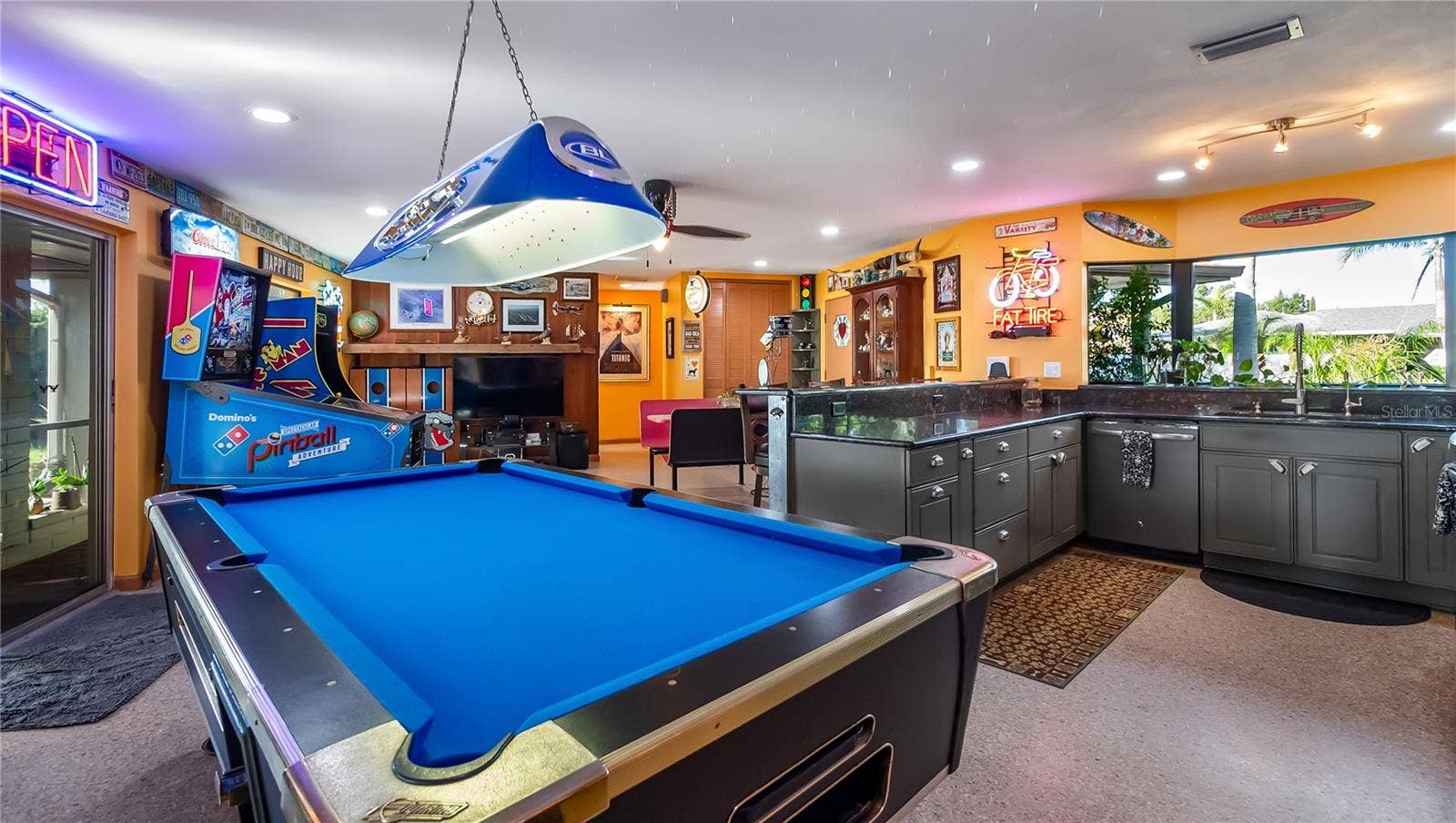 1730 NITA PLACE, Clermont, FL 34711 Main Home - Great room/kitchen/living room combo: Living room used as gathering space for game room fun. Two Sliders go out to covered back porch and screened in pool