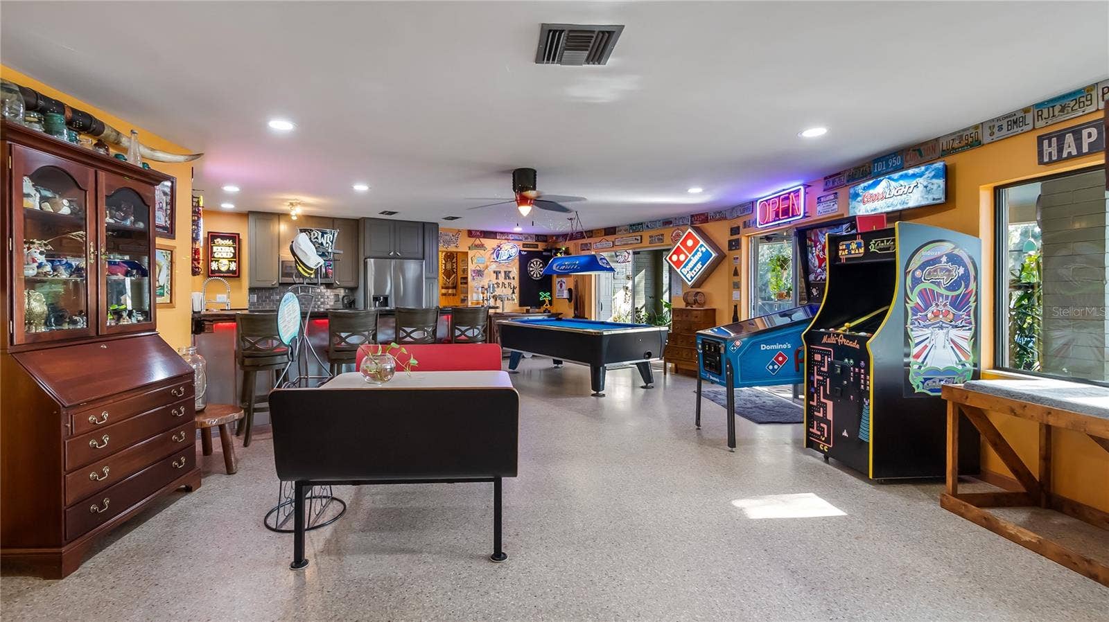 1730 NITA PLACE, Clermont, FL 34711 Main Home - Great room/kitchen/living room combo: Living room used as gathering space for game room fun. Two Sliders go out to covered back porch and screened in pool