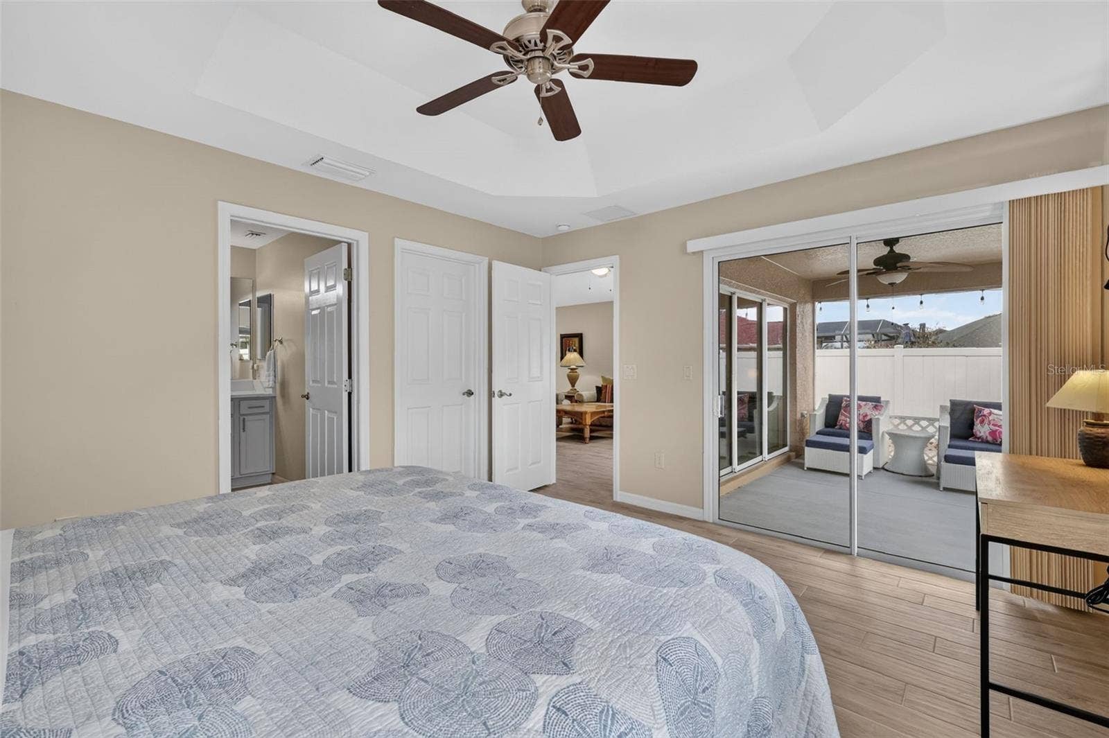 3435 ALLISON PLACE, The Villages, FL 32163 Primary Bedroom with En-Suite Bath and Sliding Doors to the Lanai
