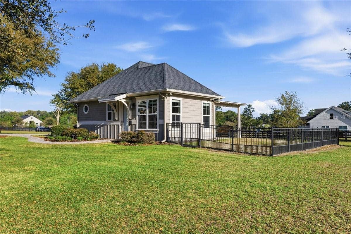 10401 NW 153RD TERRACE, Alachua, FL 32615 Detached guest house features two bedrooms, full kitchen, one bathroom, living area & stackable washer/dryer.