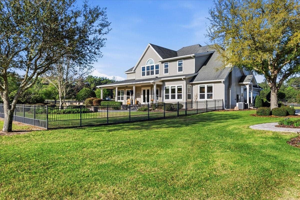 10401 NW 153RD TERRACE, Alachua, FL 32615 The perimeter of the property is fully-fenced with wood fencing and the backyard of the main home is fenced with beautiful black aluminum fencing.
