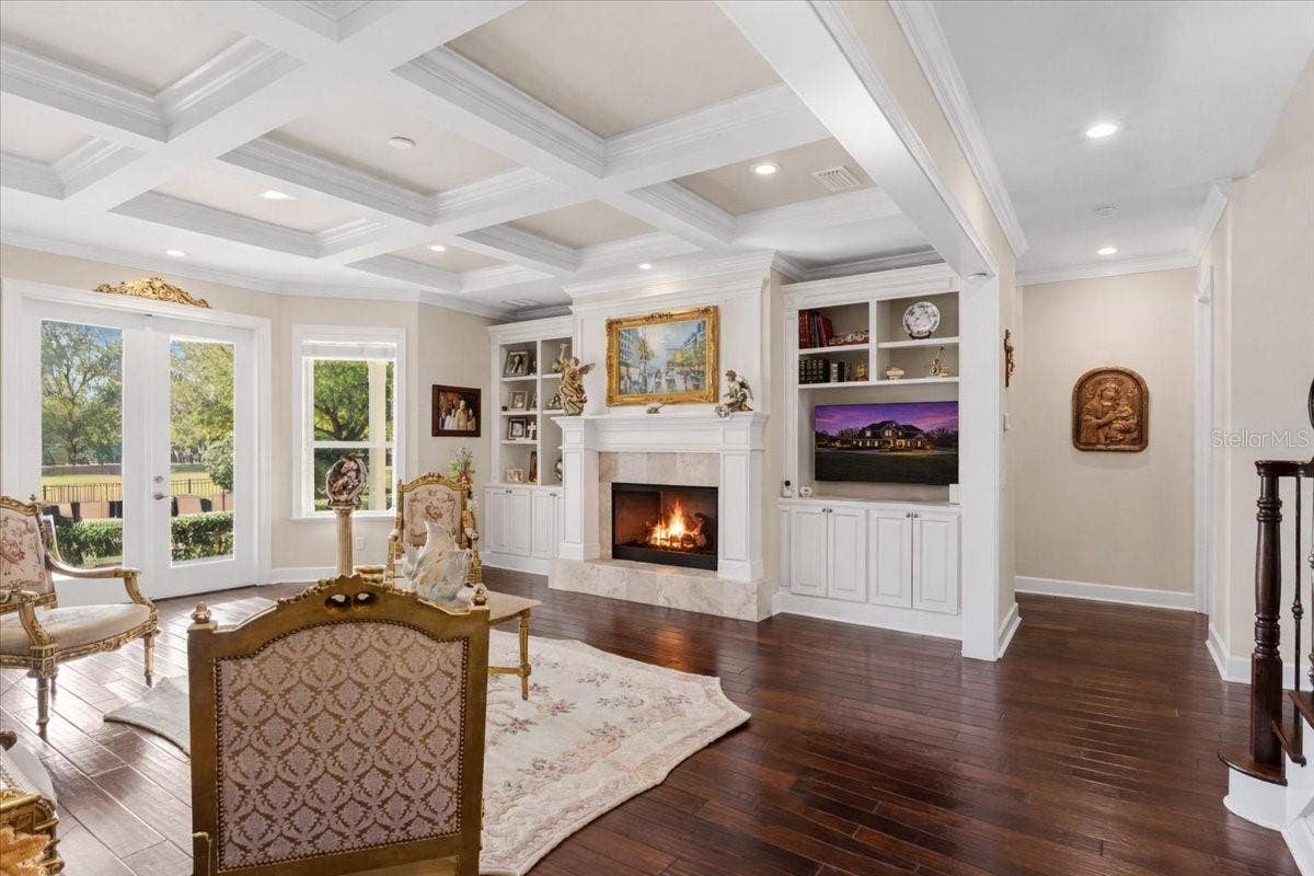 10401 NW 153RD TERRACE, Alachua, FL 32615 Custom coffered ceiling in formal living room. Custom built-ins surrounding gas fireplace.