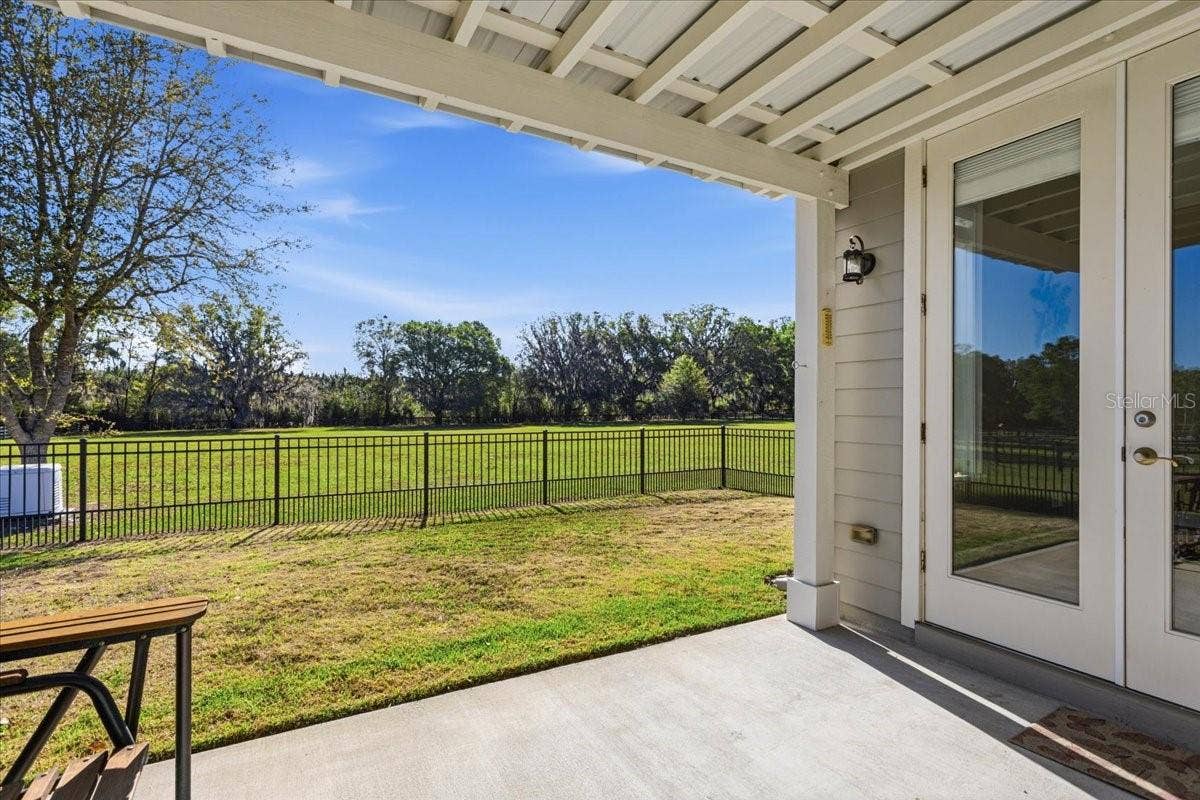 10401 NW 153RD TERRACE, Alachua, FL 32615 Covered Guest House lanai with fenced yard and generator