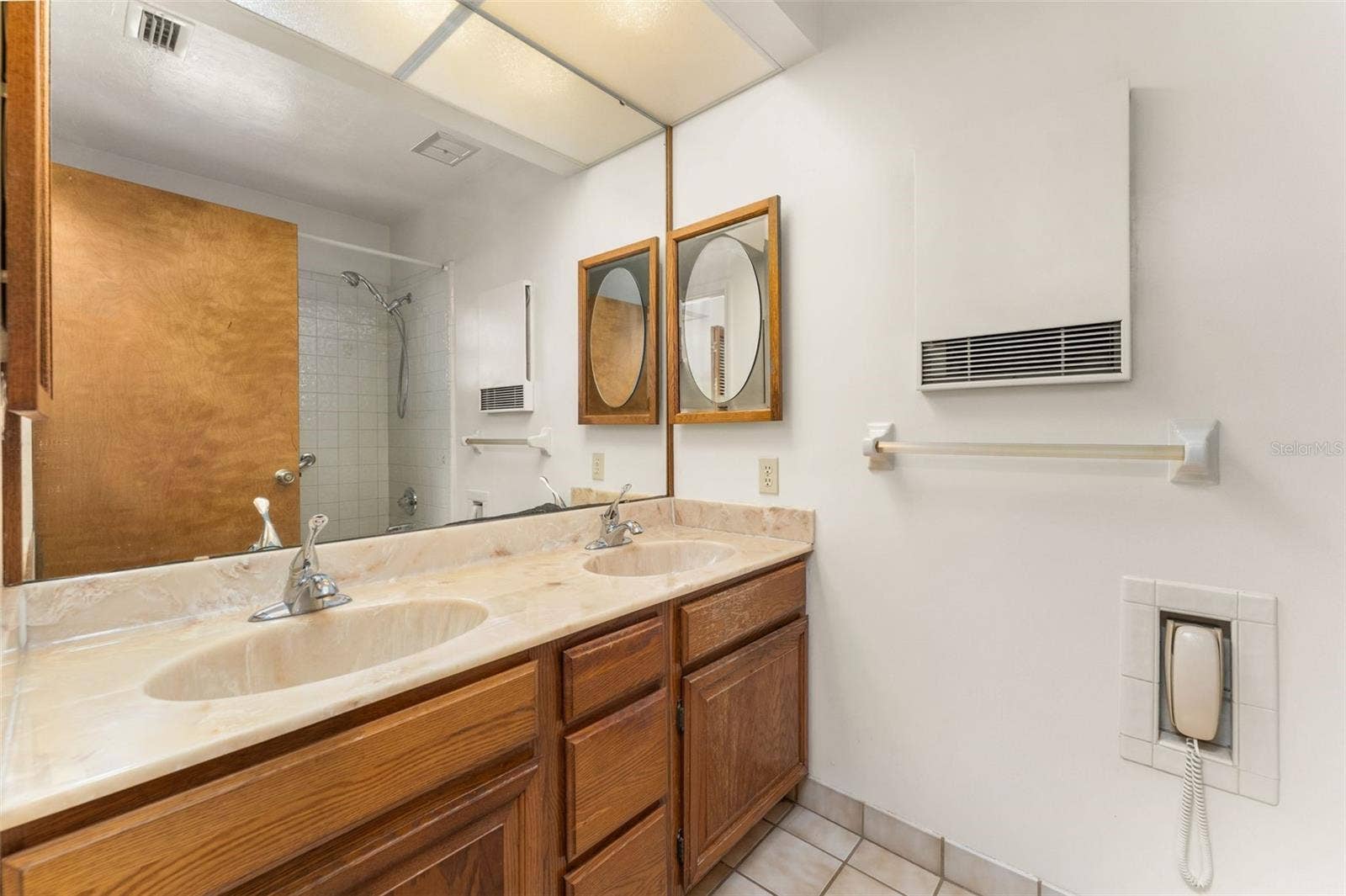Primary bathroom with dual sinks and tub/shower