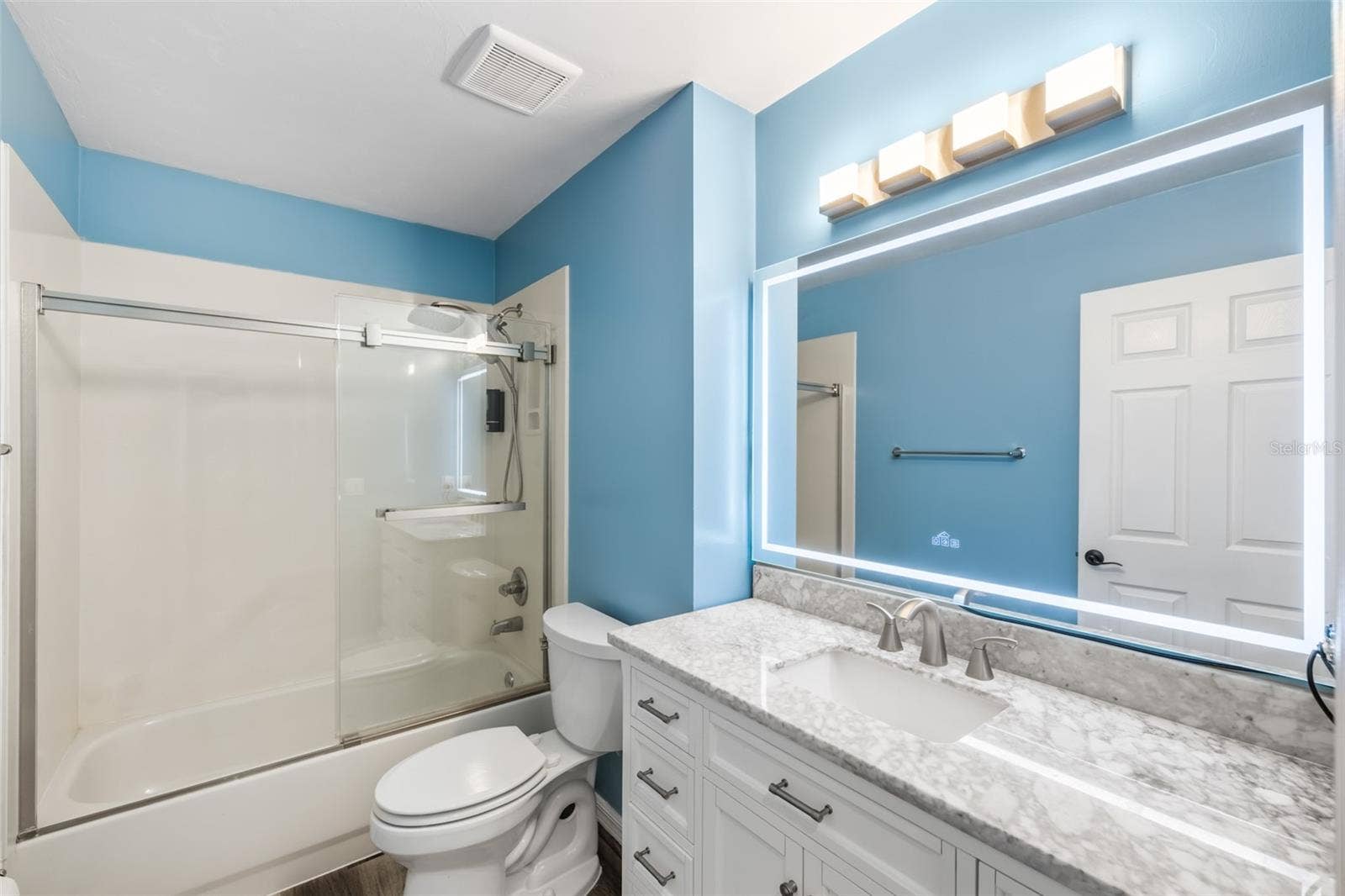 Second bathroom with lighted mirror.