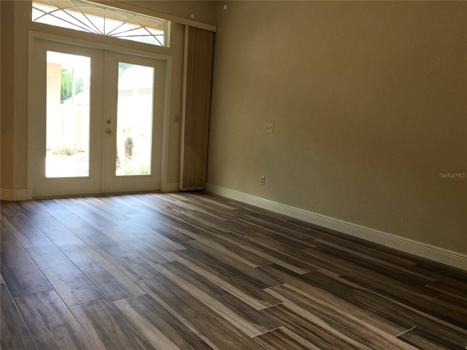 master bedroom with doors opening to courtyard