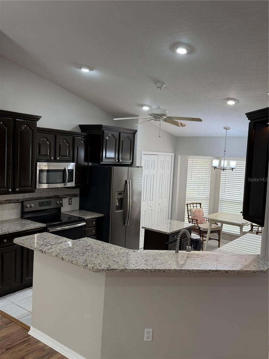 1019 GARDENIA STREET, Sebastian, FL 32958 Kitchen with Granite Counter Tops