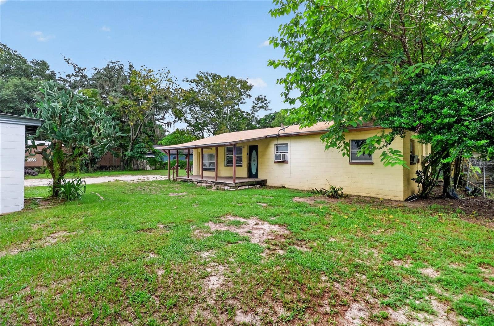 1529 COUNTY ROAD 547 N, Davenport, FL 33837 Yard between house and store