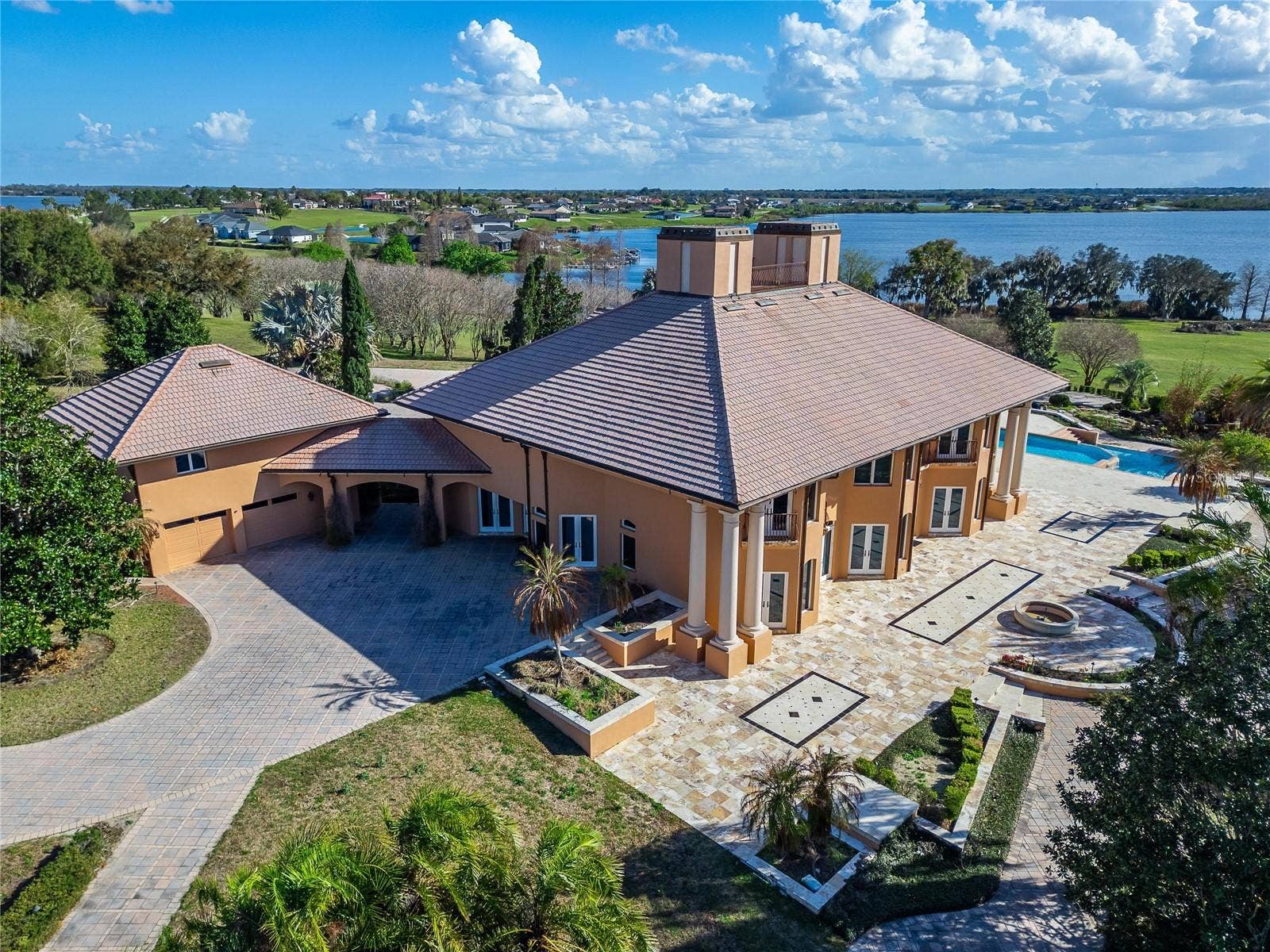 501 ADAMS BARN ROAD, Auburndale, FL 33823 Completing the property are two separate two-car garages, including a beautifully finished main garage with tiled flooring and cherry wood walls and ceilings.