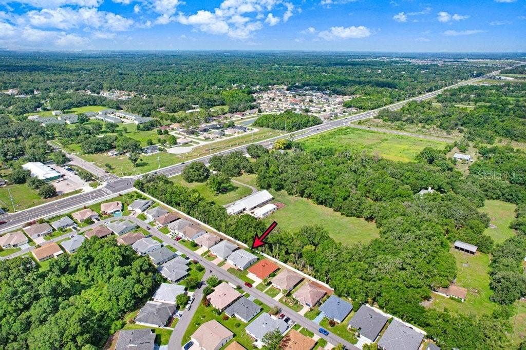 4949 Pleasant Hollow Trail with rear community fence and nearby trees providing shade and beauty.