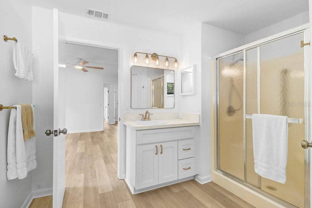 Primary Bath with separate toilet closet and large walk in closet. New vanity, door and cabinet hardware, lights and toilet.