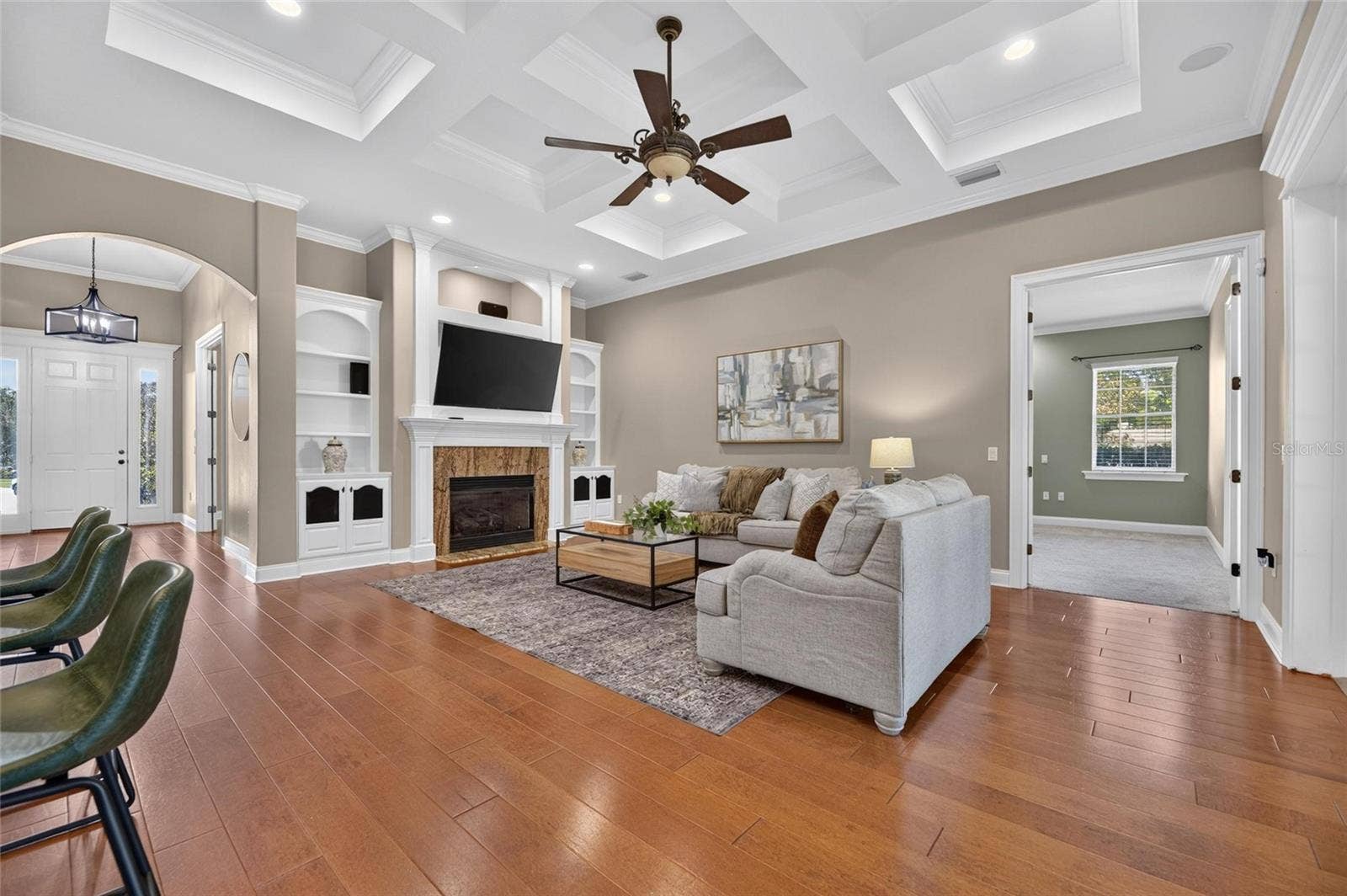6408 WALKERS GLEN DRIVE, Lakeland, FL 33813 Stunning Living room with tray ceiling, gas fireplace, custom built in and beautiful hardwood flooring