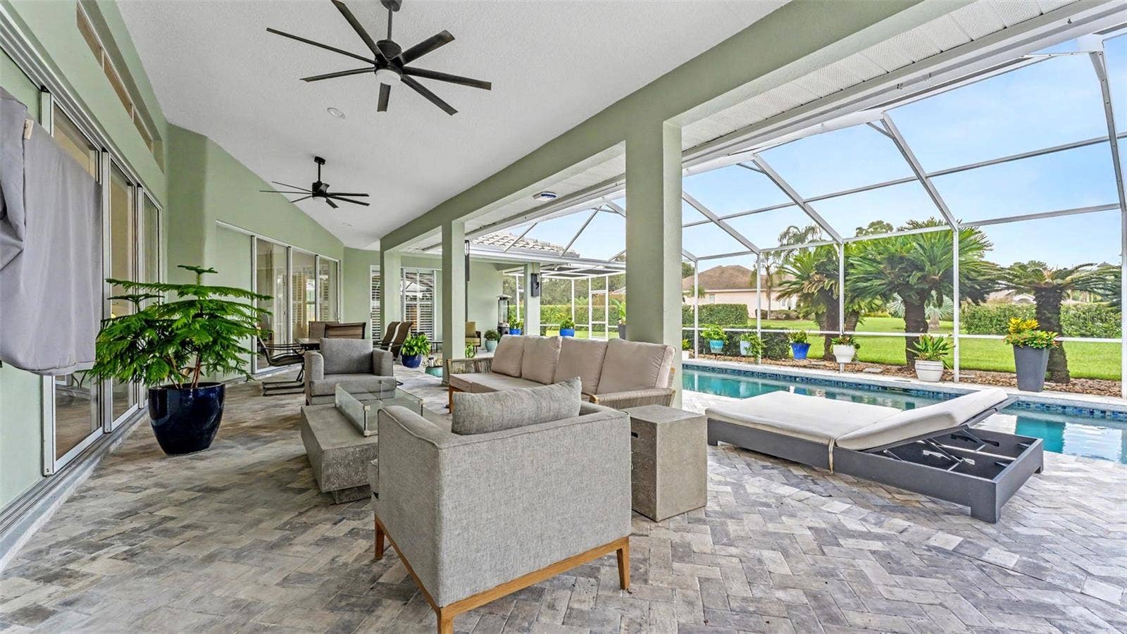 Large screened lanai overlooking saltwater pool with plenty of room for entertaining and sunbathing