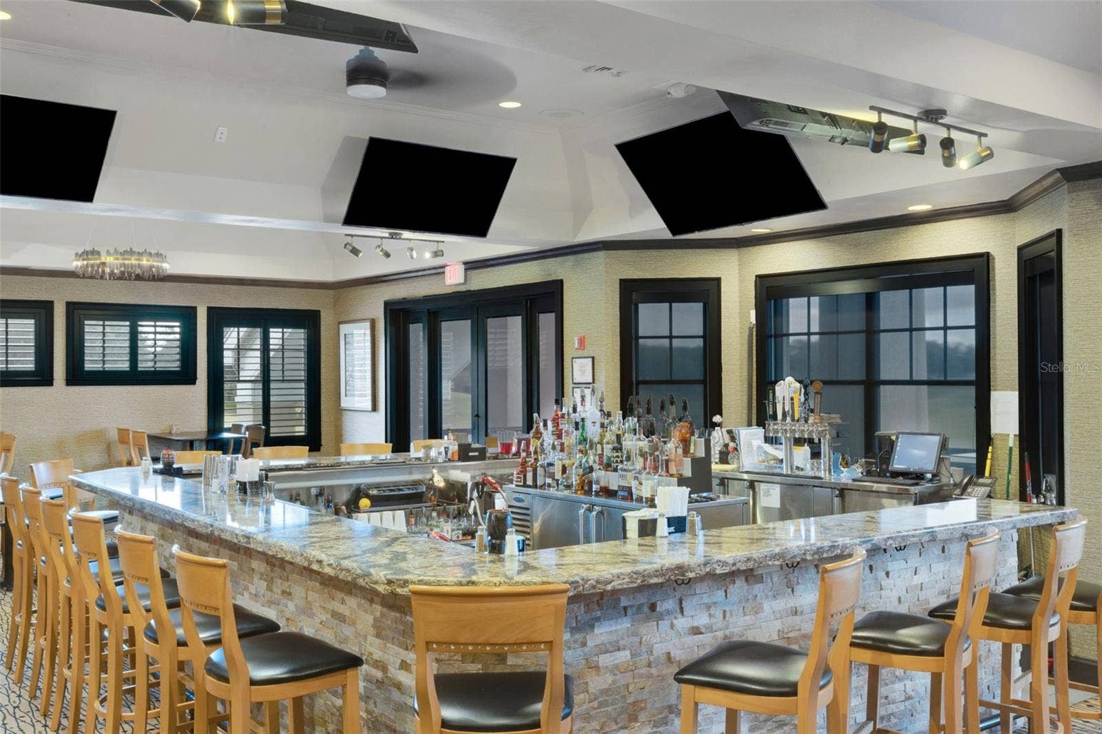 2734 BELLERIVE DRIVE, Lakeland, FL 33803 And the U-Shaped Bar features a view and sports on TV at the same time.