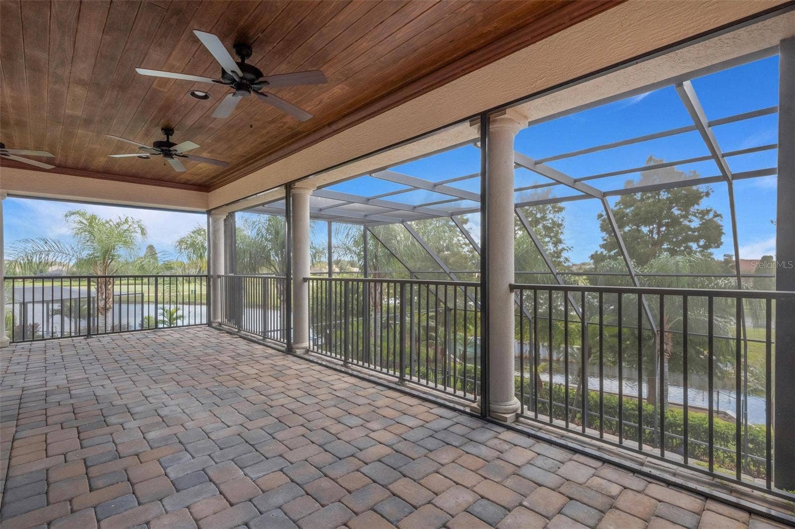 2734 BELLERIVE DRIVE, Lakeland, FL 33803 The large screen enclosed balcony overlooks the pool below and the golf course and waterways beyond.
