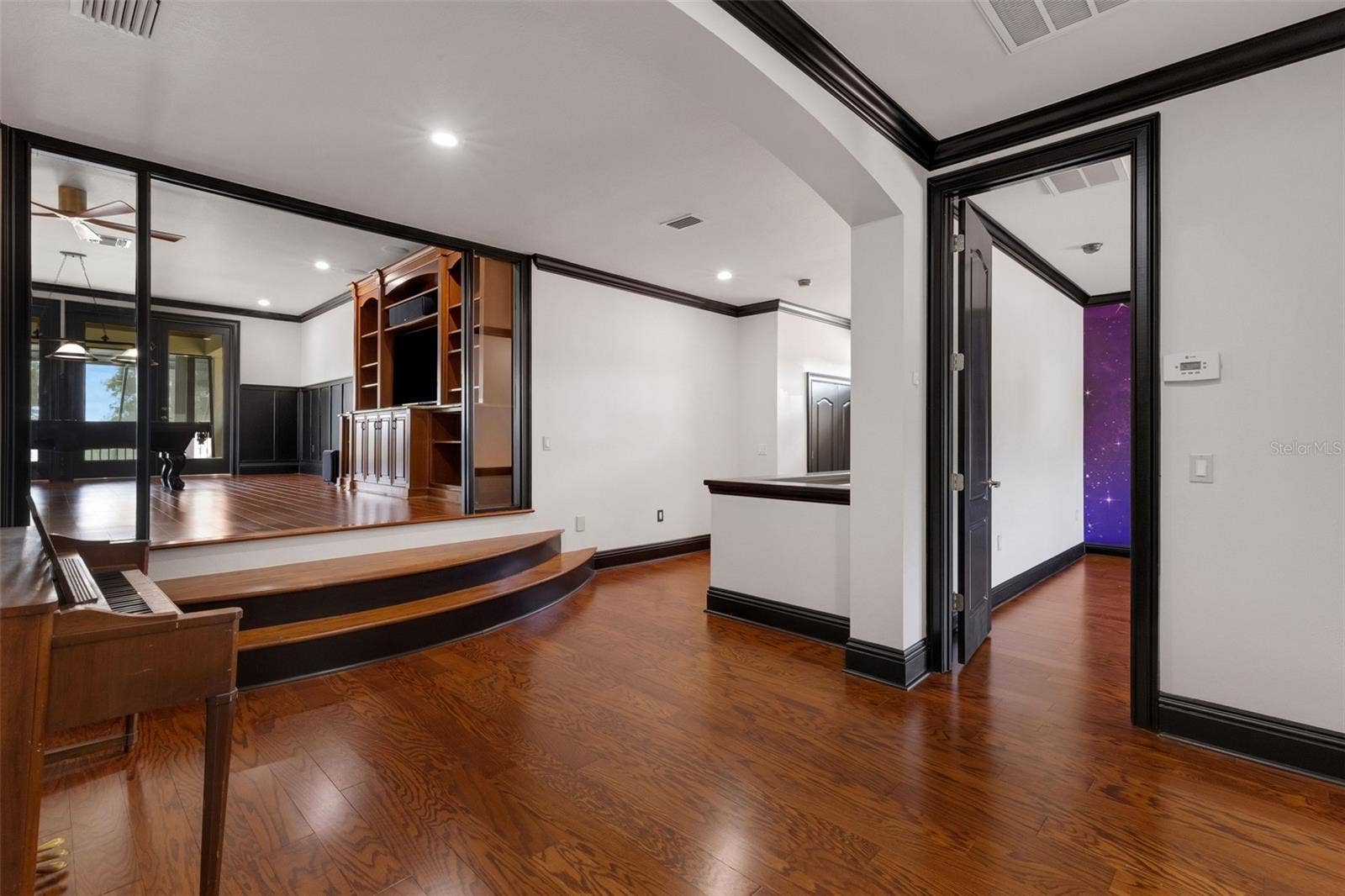 2734 BELLERIVE DRIVE, Lakeland, FL 33803 At the top of the stairway is an open common area leading to the elevated 19' x 25' game room.