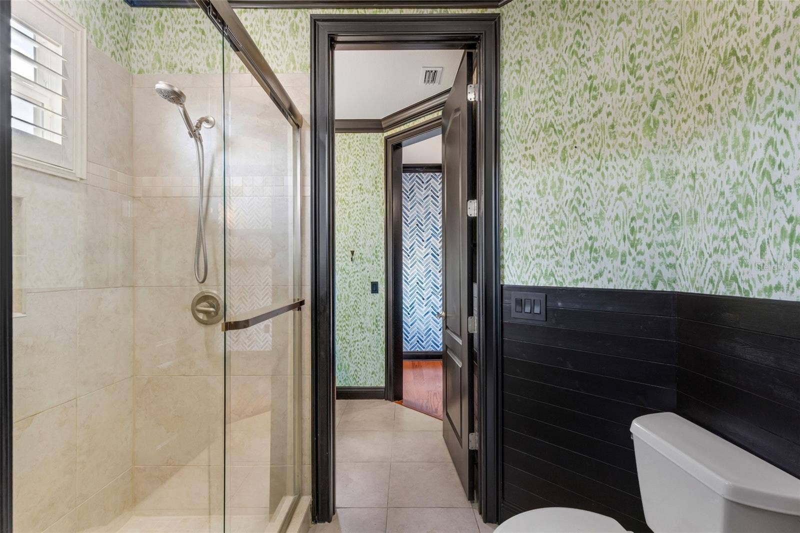 2734 BELLERIVE DRIVE, Lakeland, FL 33803 The shared part of this bathroom has a fully tiled shower with custom glass enclosure.