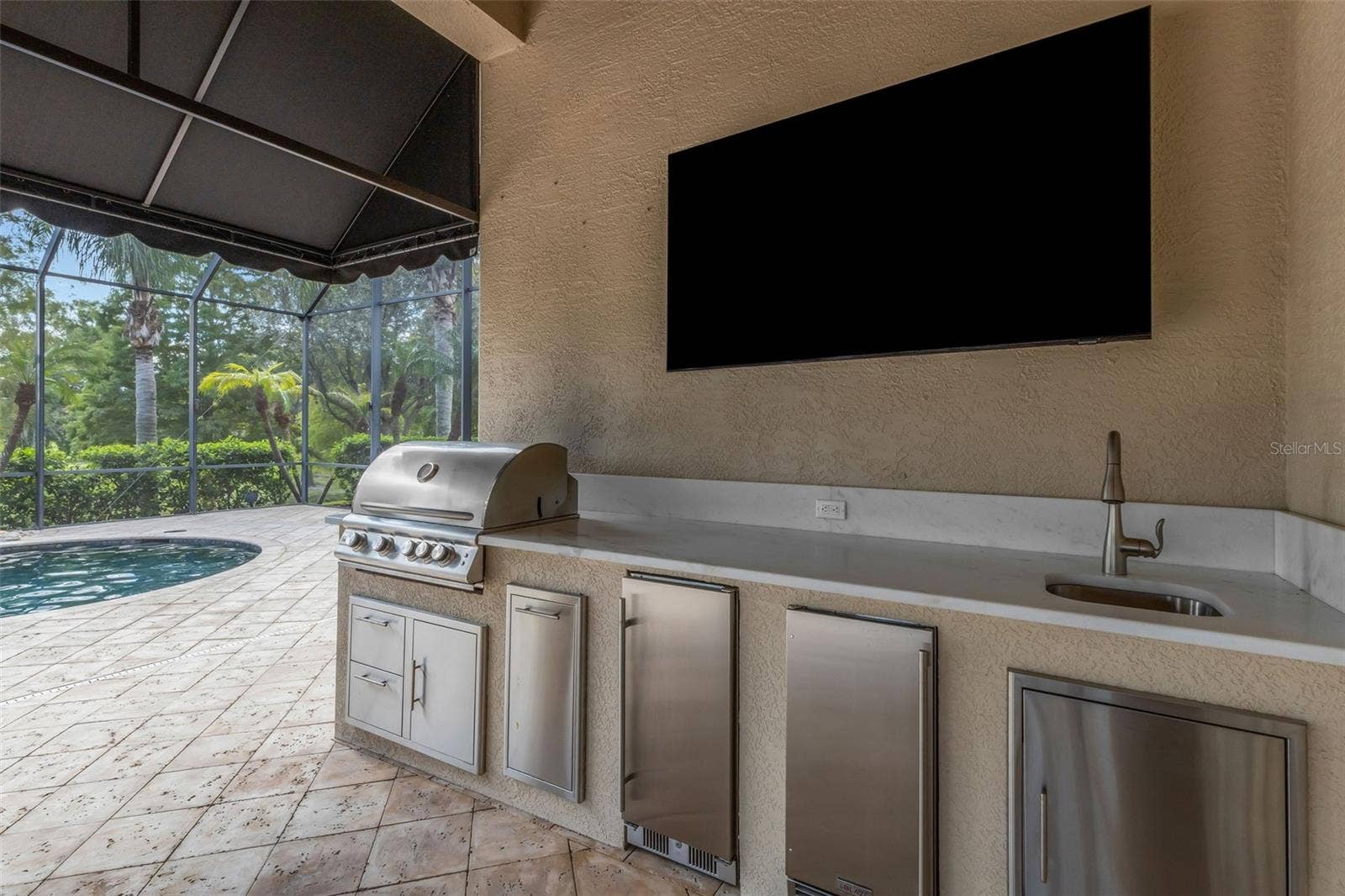 2734 BELLERIVE DRIVE, Lakeland, FL 33803 Where you will find a built-in summer kitchen with gas grill, refrigeration units, sink and more!